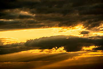 The heavenly light of the sun.Dramatic evening sky with clouds and rays of the sun.Sunlight at evening sunset or morning dawn.Panoramic view of the blue sky with clouds in motion.Heaven sunset