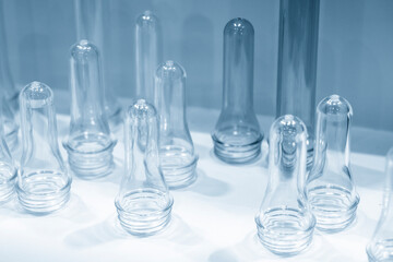 The sample parts injection preform shape of PET bottle products. The plastic bottle manufacturing process concept.