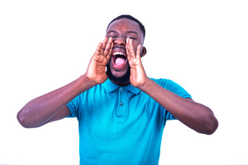 young man shouting loudly with hands near mouth.