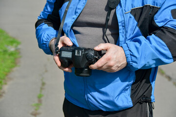 A man looks through the captured images, photographed with a SLR