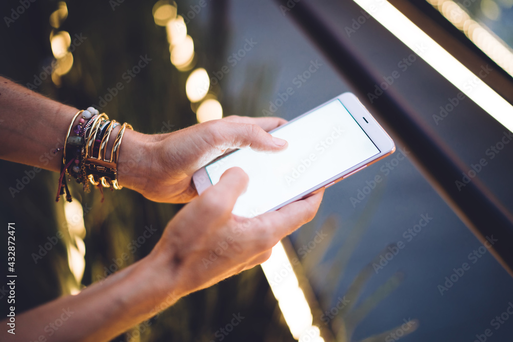 Poster cropped view of unrecognizable woman holding smartphone device typing text information on blank disp