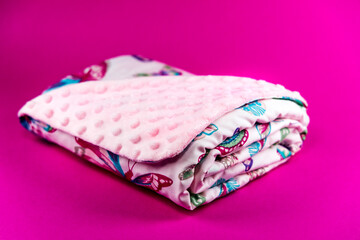 Sweet and cute baby blanket with butterfly pattern isolated on pink background