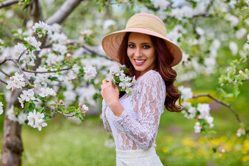 Beautiful natural woman in the garden of apple