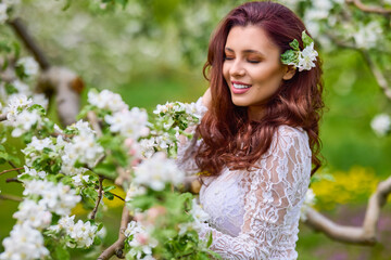 Beautiful natural woman in the garden of apple