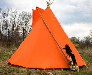 woman near the wigwam © Alla