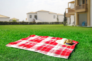 Summer background of blanket on grass and free space for your decoration. 