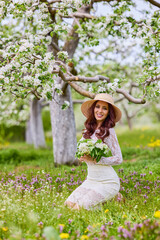 Beautiful natural woman in the garden of apple