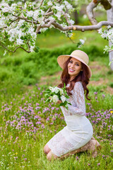 Beautiful natural woman in the garden of apple