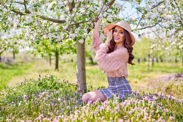 Beautiful natural woman in the garden of apple