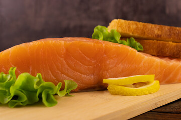 Salmon steak with lettuce leaves