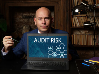 Financial concept about AUDIT RISK with inscription on the computer. the risk that...