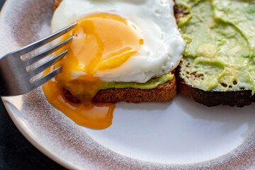 Sandwiches with scrambled eggs and guacamole. Gastronomic concept.