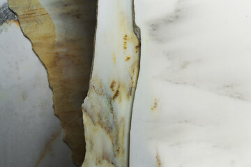 Several slabs of white marble, stacked one on top of the other