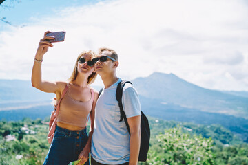 Man and woman taking selfie on smartphone