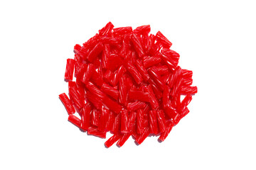 big pile heap of bright red licorice sweet candy treat on a bright white studio counter table as a food scene
