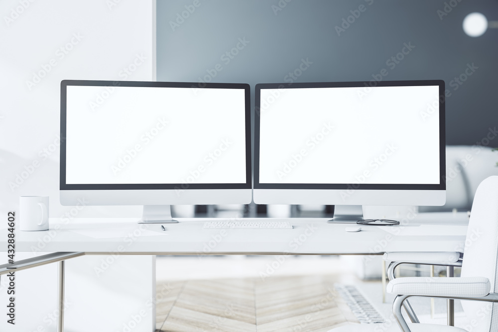 Aufkleber blank white modern computer monitors as a part of stylish work place with light table in sunny room 
