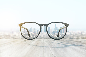 Glass lying on the surface with cityscape view in the background. Perspective and travel concept, 3d rendering