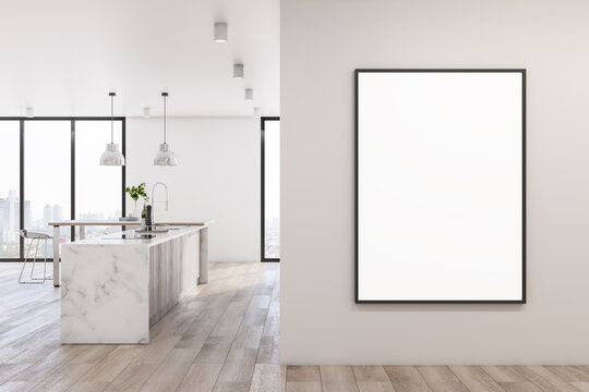 Blank white poster in black frame on light wall in spacious kitchen area with wooden floor, city view from windows to floor and marble tabletop in the center. 3D rendering, mockup