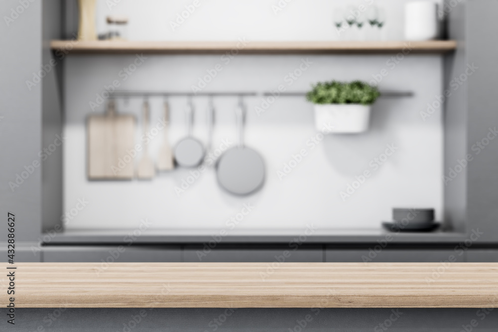 Aufkleber modern light wooden tabletop with copyspace for your text at blurry kitchen utensils and dishes on g