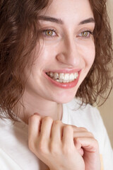 Young woman smiles with clean aligners on her teeth