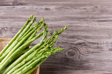 Fresh Asparagus. Bunch of fresh ripe green asparagus organic vegetables ready to cook. Group of Fresh asparagus on the wood background. Raw vegetable food for health cook