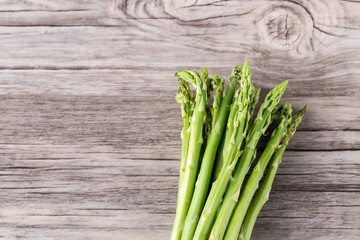 Fresh Asparagus. Bunch of fresh ripe green asparagus organic vegetables ready to cook. Group of Fresh asparagus on the wood background. Raw vegetable food for health cook