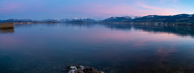 Fototapeta premium Beautiful seaside landscapes along the Frauenwinkel nature reserve on the shores of the Upper Zurich Lake (Obersee) between Hurden and Rapperswil, Switzerland
