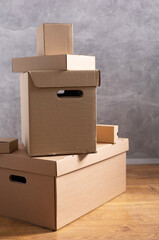 Stack of cardboard box on floor. Cardboard boxes for moving to new home. Relocation concept