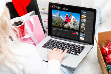 Woman watching videos online on laptop