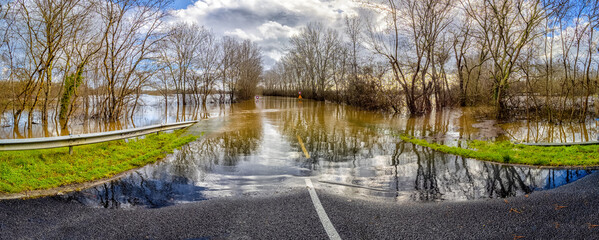 The road is blocked due to the Isle River overflowing its banks