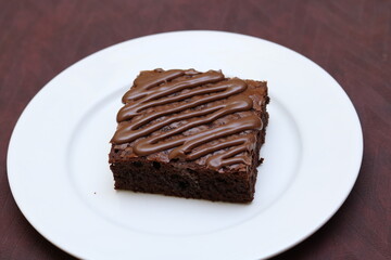 Chocolate Brownie in white plate on wooden background