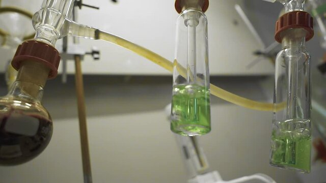 Hitting the camera (Dolly Zoom), close-up of test tubes boiling on fire. slow motion.120 frames per second.