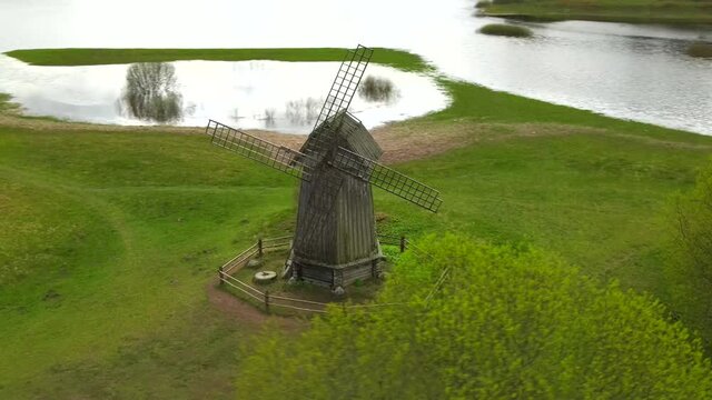 Aerial drone view of old vintage wooden windmill in spring summer time. Russian countryside. 