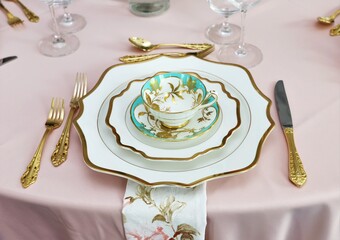 Close up of table set up for bridal shower, vintage tea set and floral napkins