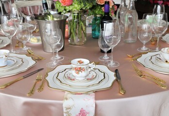 Close up of table set up for bridal shower, vintage tea set and floral napkins