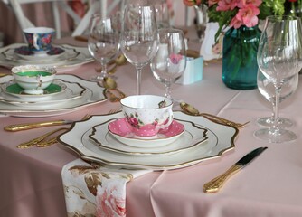 Close up of table set up for bridal shower, vintage tea set and floral napkins