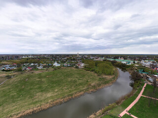 Fototapeta na wymiar a panoramic view of the historical center of the temples and monasteries of the city of Suzdal in the rain filmed from a drone 