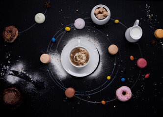 Fototapeta premium cup of coffee, donuts, macaroons, sugar, milk cream jug and cakes on the black background look like coffee system
