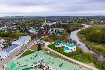 a panoramic view of the historical center of the temples and monasteries of the city of Suzdal in the rain filmed from a drone 