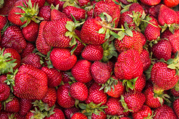 many strawberries in a market, summer background