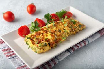 Fresh French omelet with fresh vegetables. Vegetarian food