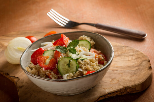 quinoa salad with tomatoes pepper cucumber onion and mint leaf