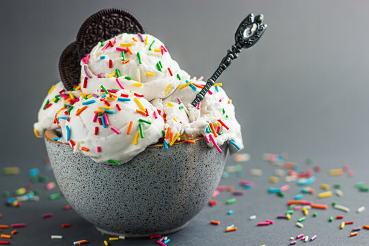 vanilla ice cream with colored sprinkles in a ceramic bowl