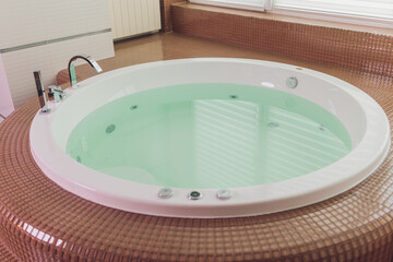 jacuzzi bath tub on marble floor with water.