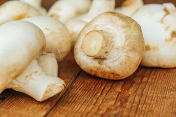 Large mushrooms. Mushrooms on a wooden background, cooking fresh mushrooms.