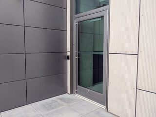 a side entrance door for a business building with a keyless entry box on the side - Powered by Adobe