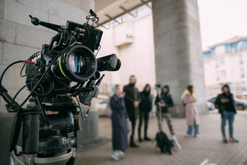 Professional film and video camera on the set. Shooting shift, equipment and group. Modern...