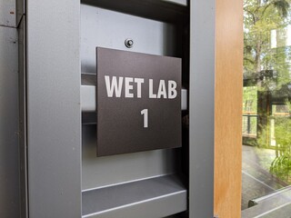 square sign on the exterior of a wet lab building at a wildlife conservation