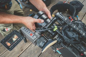 Professional film and video camera on the set. Shooting shift, equipment and group. Modern photography technique.