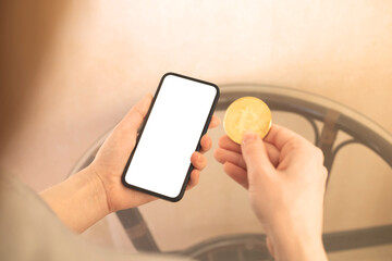 Woman shopping with crypto coin, mockup with bitcoin and blank white screen of mobile phone, copy space photo